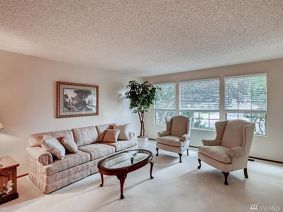 To the right of the entry is the formal living room with tons of natural light from the wall of windows.
