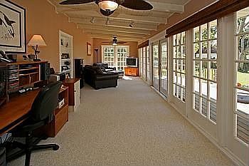 A wall of french doors brings the outside into the spacious family room.