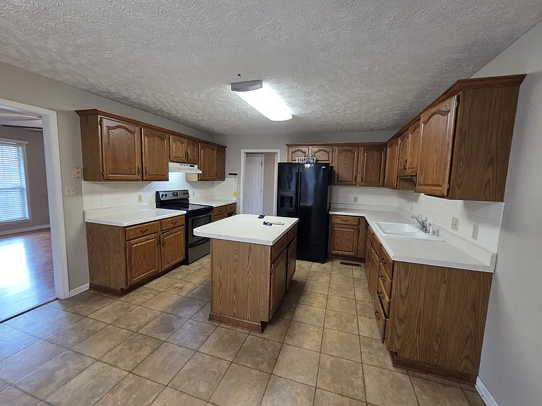Kitchen with island, and all appliances included.