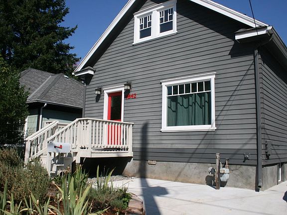 Concrete paved space in the front of the house. It could be used for additional compact parking.