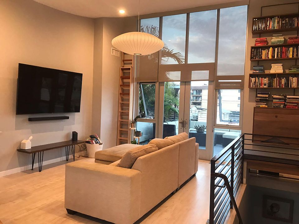 Living room and adjacent floating desk and book shelves