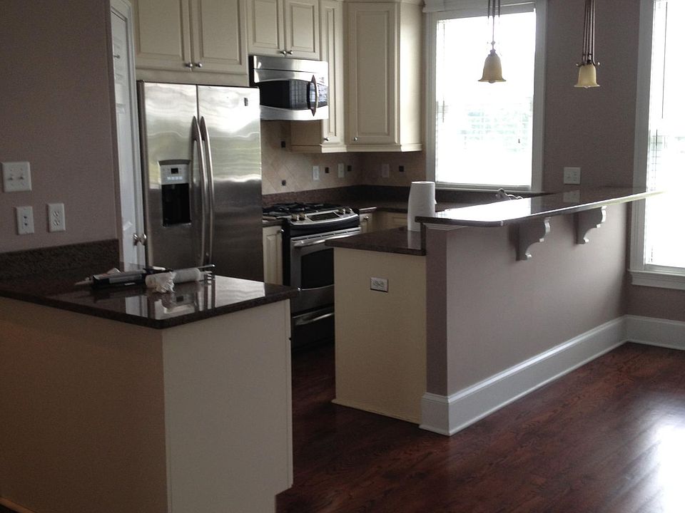 Open concept kitchen w bar seating and table area