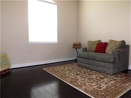 The study, currently used as a sitting room, would make a comfortable reading library, private office or music room