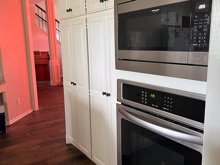 Updated stainless steel appliances with updated neutral paint.