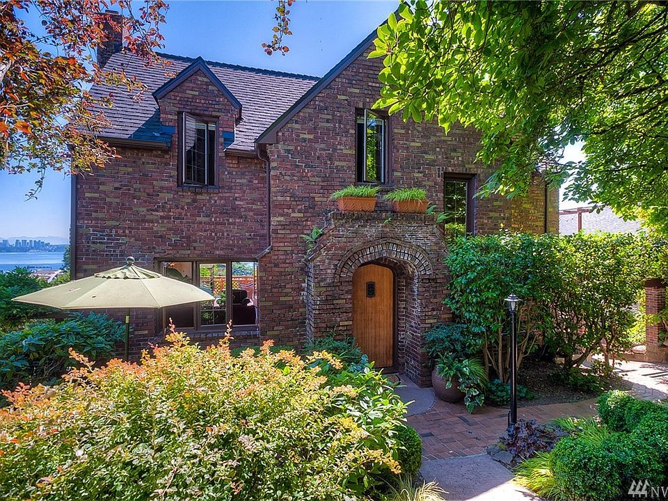 Serene brick Tudor with spectacular lake views even from the front the front yard.