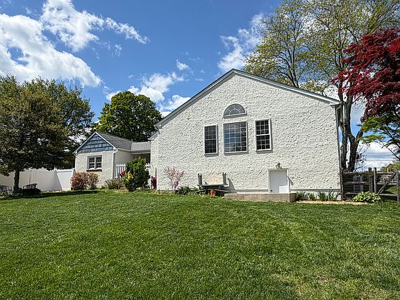 Back view with breezeway and back of garage and walkout basement entrance visible