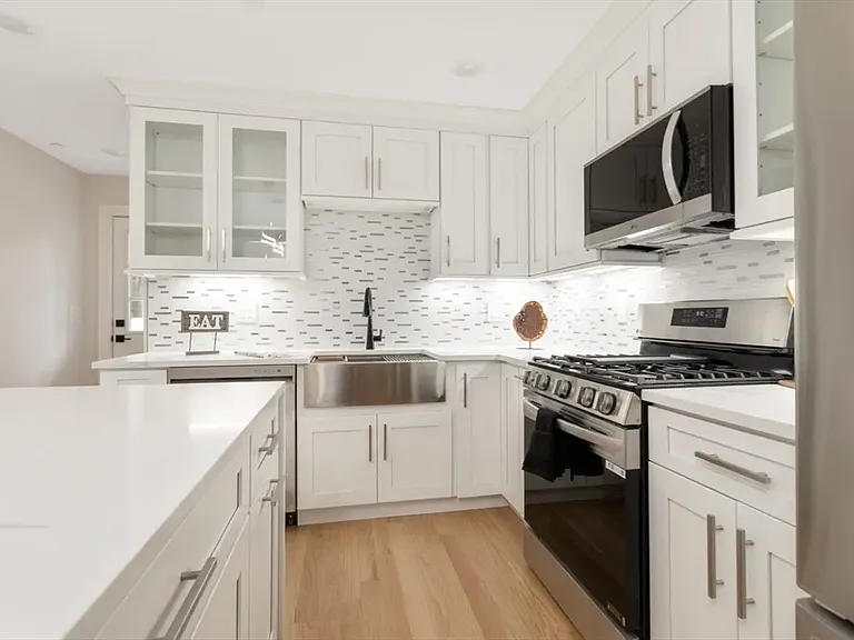 Designed for connection: Keep the conversation going from the granite island while overlooking the sun-filled dining and living areas.