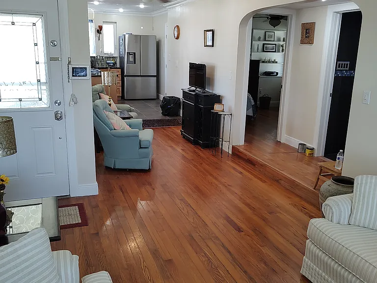 Living room full view into TV area and Kitchen