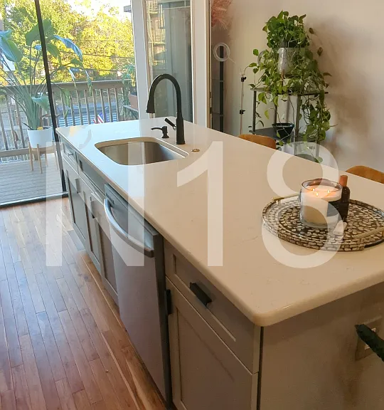 Large kitchen island & double french doors leading to private balcony