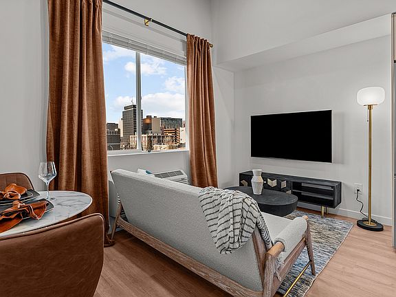 Experience modern comfort with this elegant living space and breathtaking cityscape views.