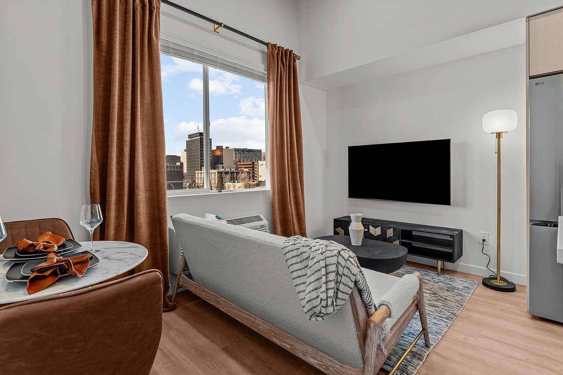 Experience modern comfort with this elegant living space and breathtaking cityscape views.