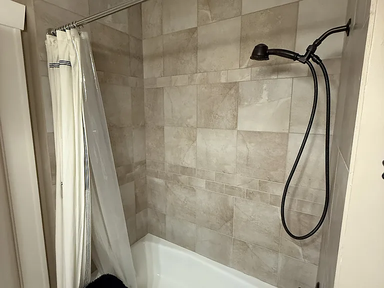 Main floor bathroom with tub shower and washer/dryer