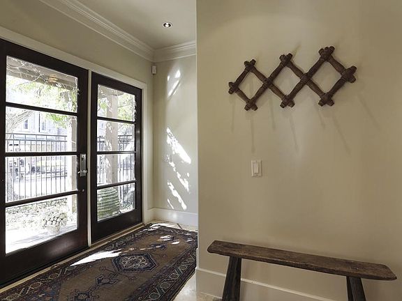 Another view of the first floor entry showing the handsome front doors which allow for an abundance 