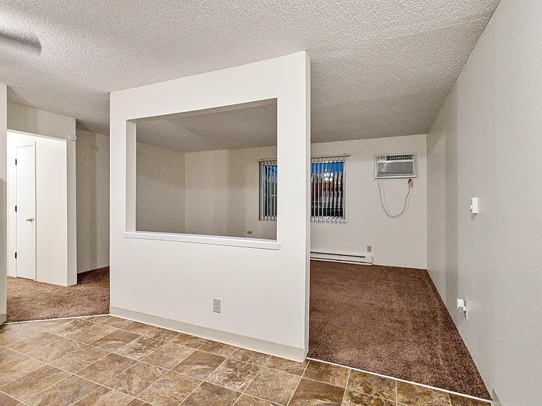 Living room with wall unit air conditioning