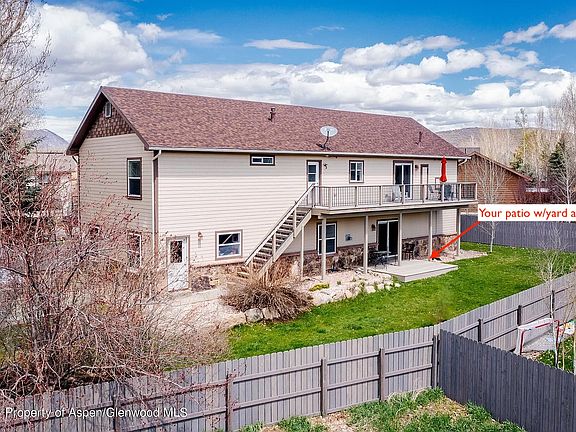 Rear of home showing lower level patio and fenced in yard accessible to both owners and tenant.