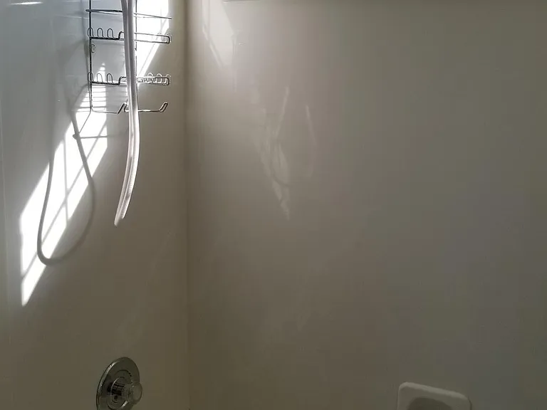 Bathtub and shower in main bathroom on the second floor. Notice the mountains through the window!