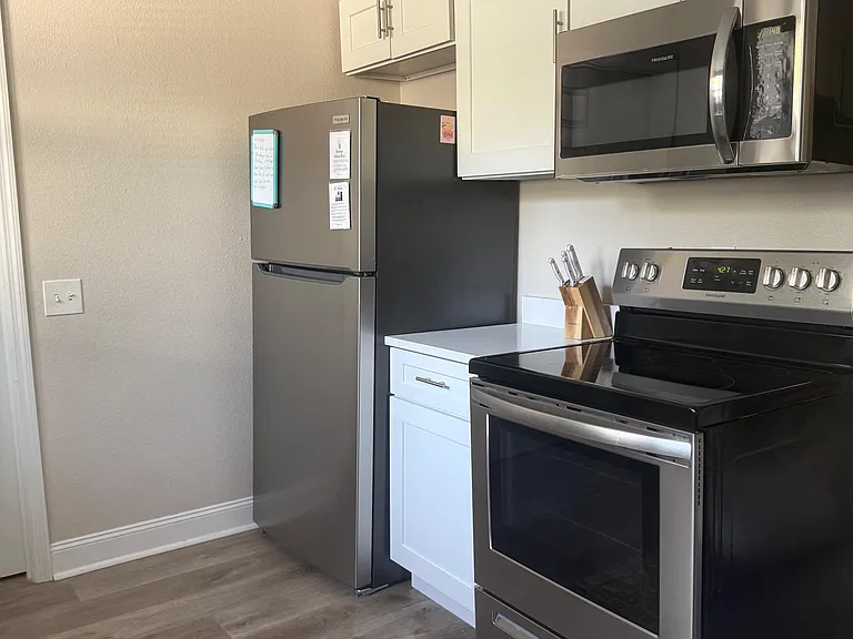 Stove and fridge and microwave in kitchen