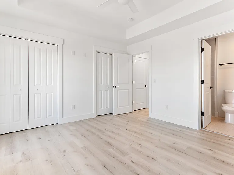 Bedroom Two has side-by-side closets, an en-suite bathroom with a walk-in shower. The room is 12'10" x 12'3". The deck is beautifully appointed with two poly-resin rocking chairs and a small table. It overlooks the community and the pond. Blinds included.