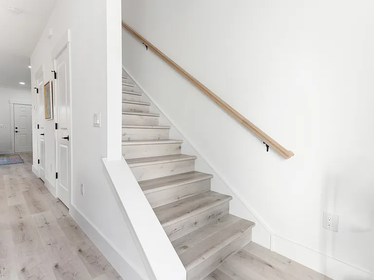 Luxury vinyl tile throughout the house. Storage under the stairs.