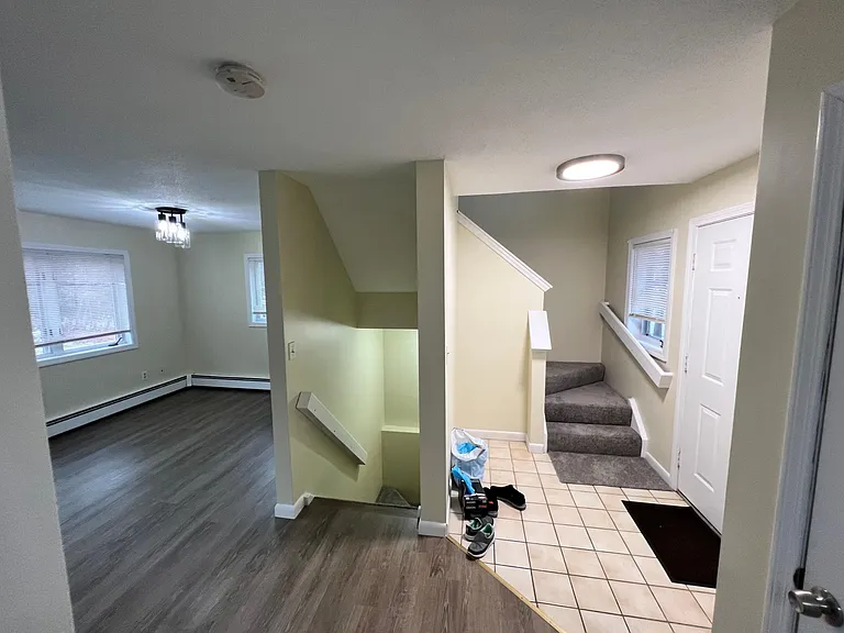 Stairs to upper and lower levels from living room