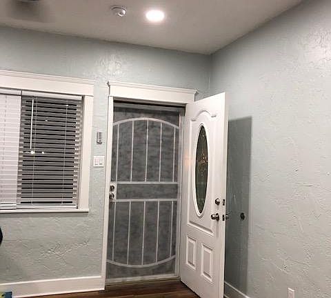 View of entry view, new windows in living room and dining room with new blinds