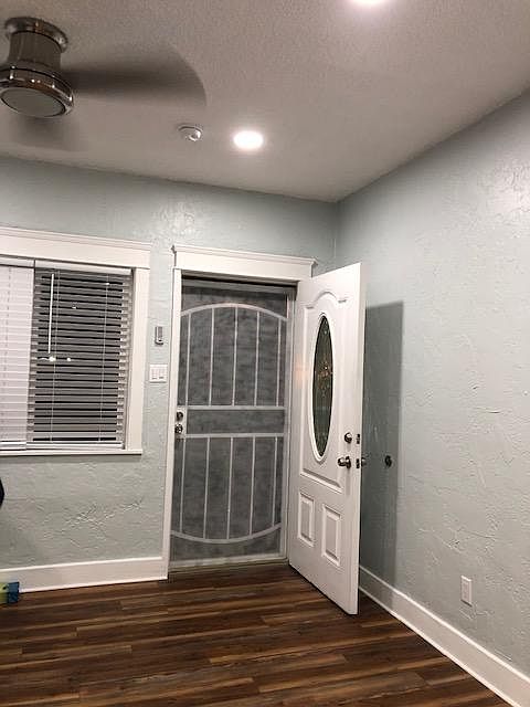 View of entry view, new windows in living room and dining room with new blinds