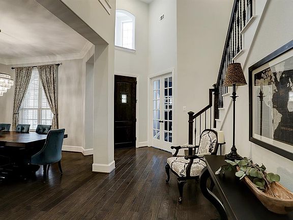 Views of two story formal entry, dining and study with French doors.