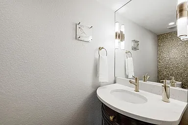 Guest half bath downstairs with decorative touches and stylish finishes.