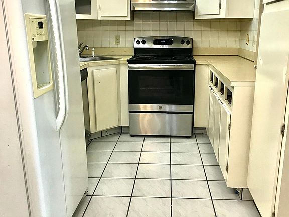 Kitchen. Freshly painted cupboards and cabinets that provide for ample kitchen storage.