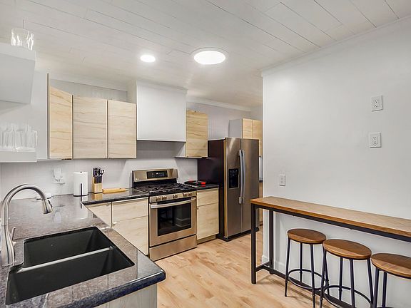 Kitchen with gas stove and seating