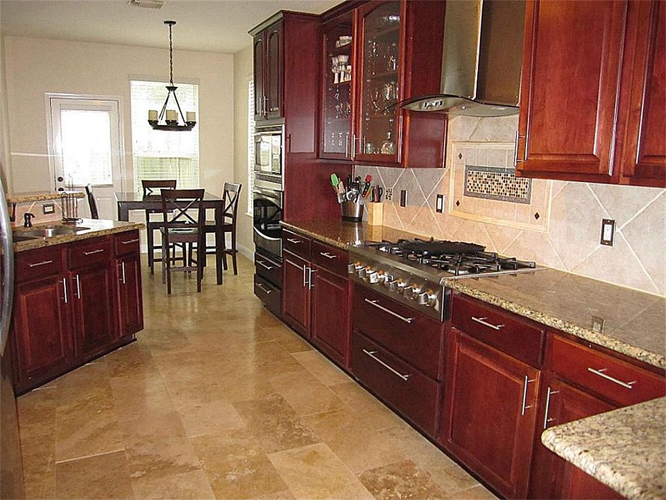 Kitchen - Angle 2 showing the oversized 6-burner gas stove, and oven, custom vent hood, etc