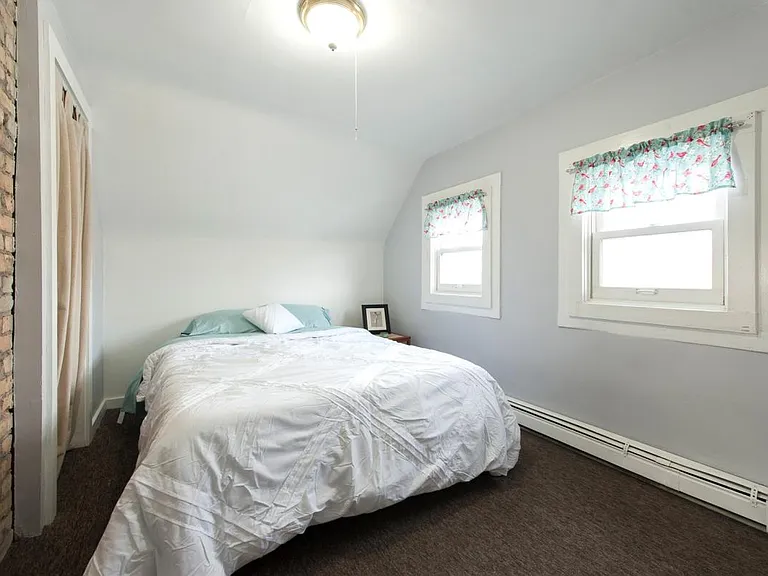 Second floor bedroom with exposed brick