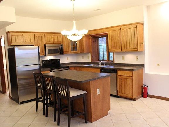 Kitchen with dishwasher, island and chairs