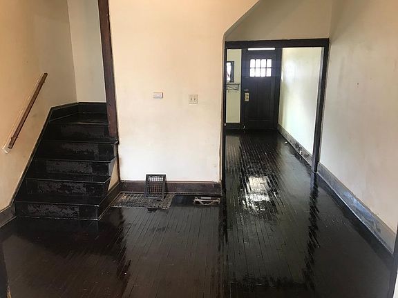second living room space, stairs into the basement and upstairs bedrooms