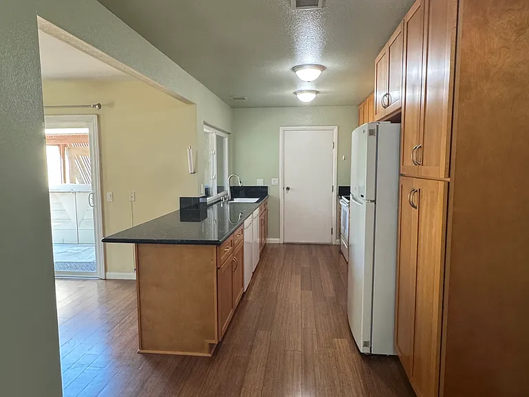 Fully equipped kitchen featuring energy-efficient appliances and a convenient breakfast bar island