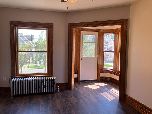 Bright living room with alcove, perfect for reading nook and plants.