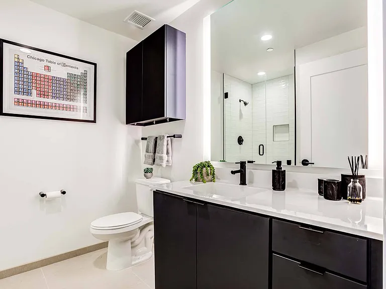 Step into a modern bathroom featuring sleek finishes and plenty of space, offering a refreshing and functional retreat.