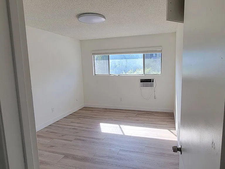 Large bedroom with lots of natural light in 2-bedroom apartment at the Hardison Apartments in Pasadena, California.