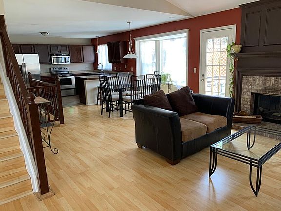 Living Room - fireplace (furniture includes 2 couches, dining set, tall plant tables and coffee table)