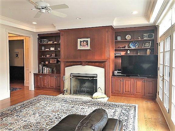 Generous sized room with fireplace, built-in cabinetry, and open to the kitchen
