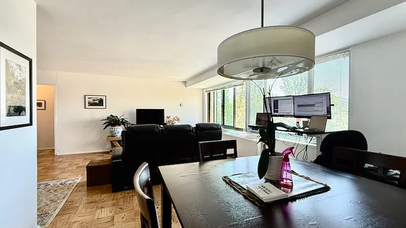 View from the dining room, with the adjustable desk to the right and the living room up ahead. The kitchen is to the left.