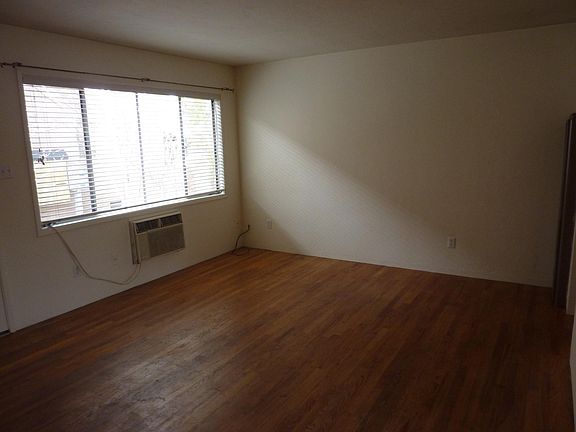 Living room with a 8' wide window onto the patio and what is now a new 24,000 BTU air conditioner.