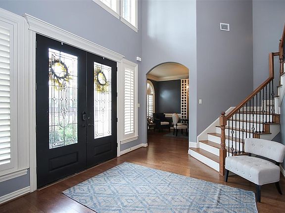 Two story entry with wood floors, updated paint and plantation shutters