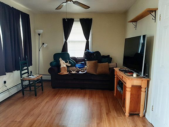 Living Room w/ Ceiling fan and coat closet