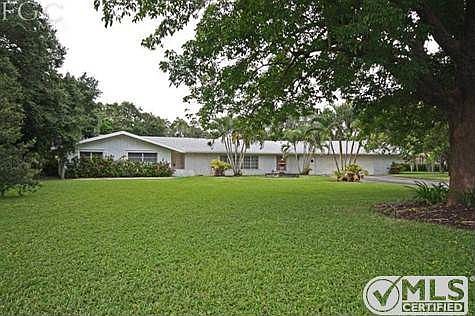 FRONT OF HOME 1.5 ACRES WITH TOWERING OAK, MANGO AND AVOCADO TREES
