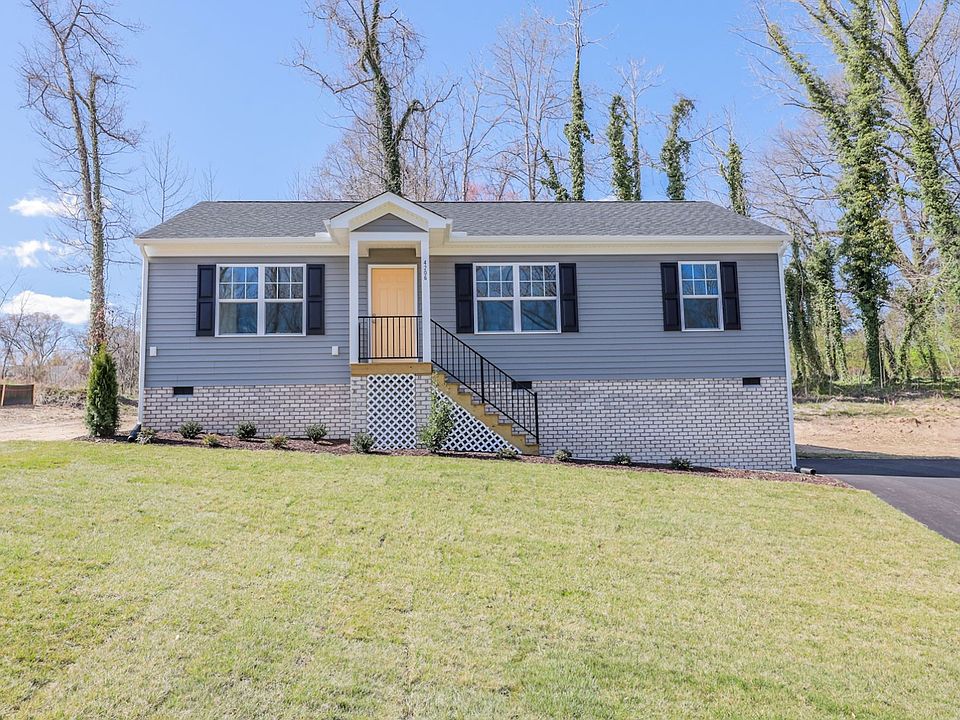 Single-story gray house with black shutters and a lawn--perfect for new homes in Richmond VA, under