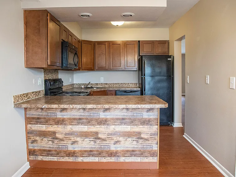 Charming kitchen with rustic wood accents, sleek appliances, and warm cabinetry for a cozy ambiance.