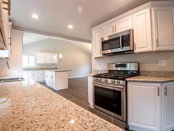 Additional view of kitchen opening to great room.