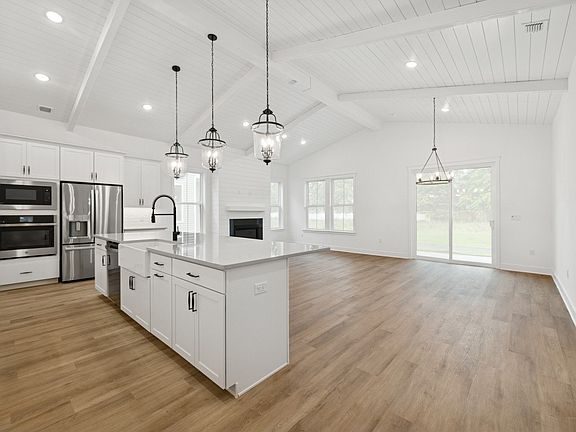 Soaring vaulted ceiling unites main living spaces