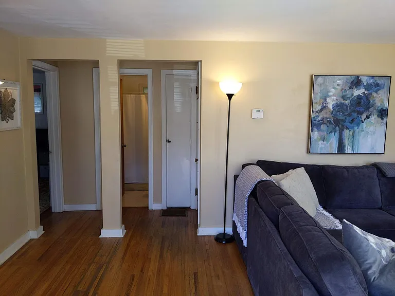 First floor bedroom or den, full bathroom, storage closet, steps to upstairs level